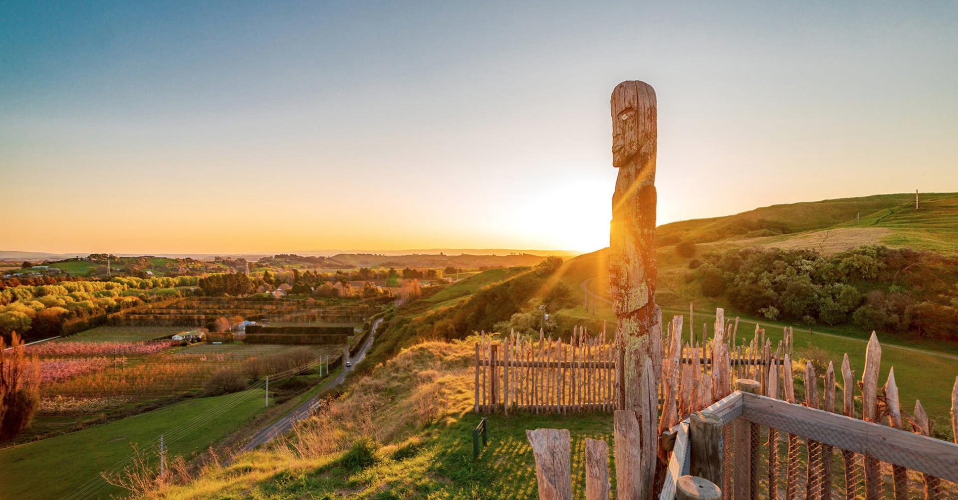 New Zealand sunrise on a sandy beach, showcasing one of the first sunrises in the world for travellers arriving in 2026.