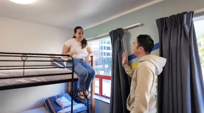 Working holiday guests and students socializing at United Auckland Hostel